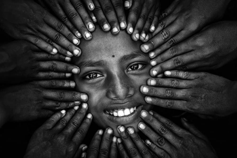 Smiling Child Many Hands by Saurabh Sirohiya — canvas wall art