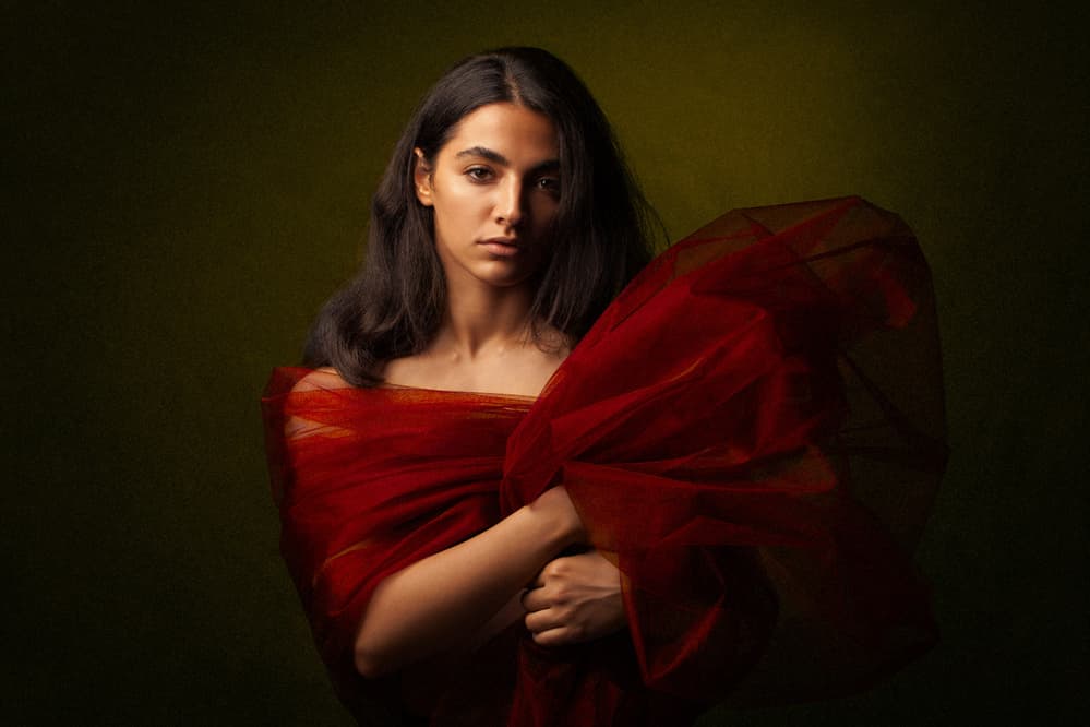 Pensive Woman In Red by Mehdi Mokhtari — canvas wall art
