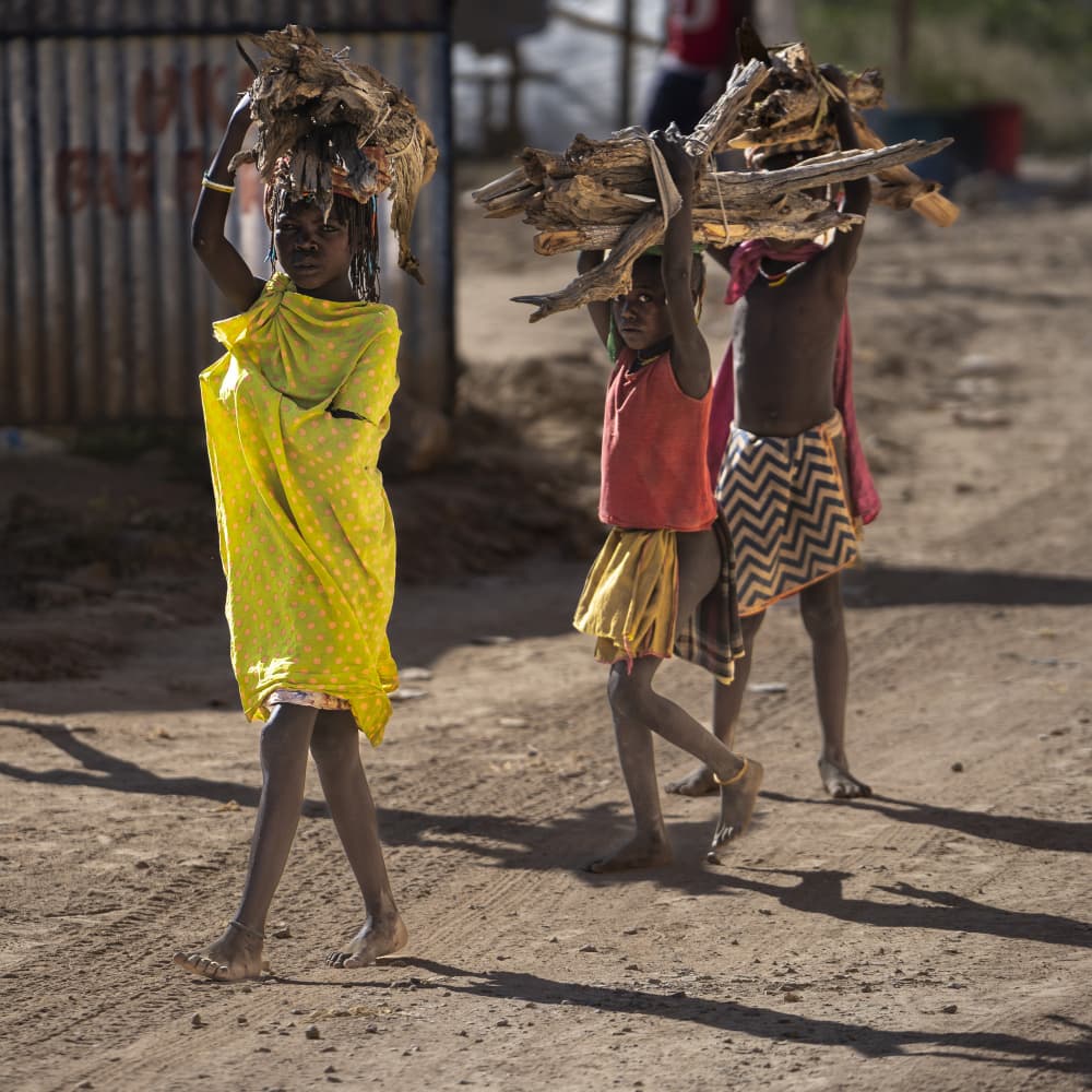 Young Girls Carrying Wood by Eyal Alcalay — canvas wall art