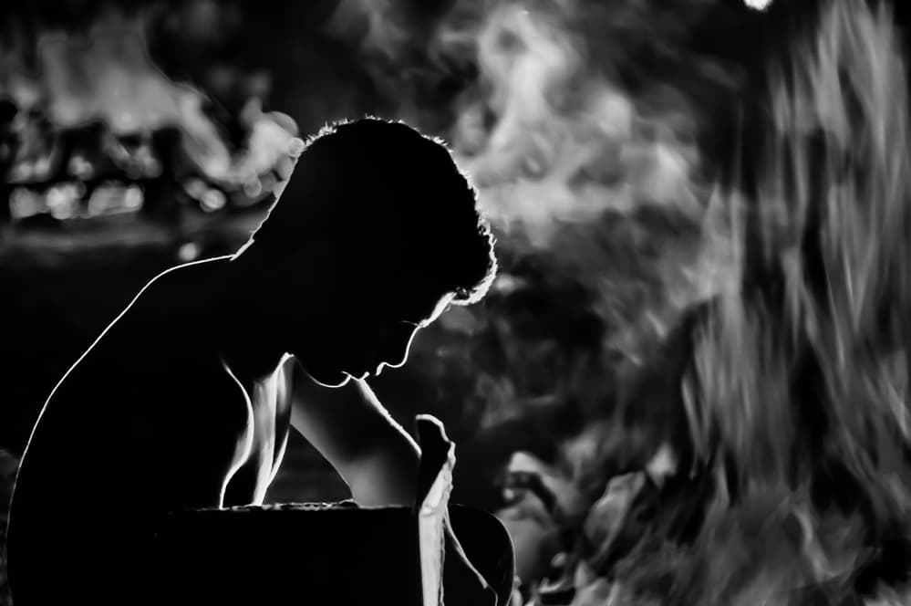 Contemplative Silhouette by Fire by Joshua Raif — canvas wall art