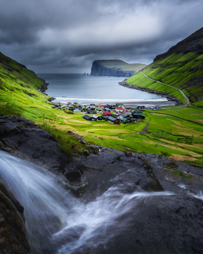 Moody Coastal Waterfall Village by Ti Wang — canvas wall art