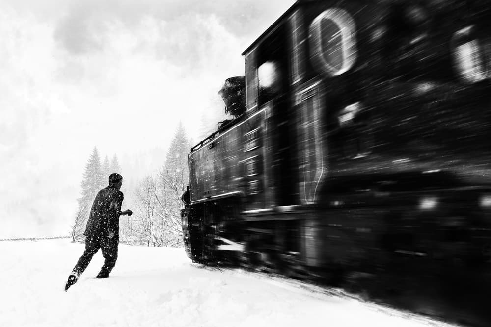 Snowy Train Chase by Marius Cinteza — canvas wall art