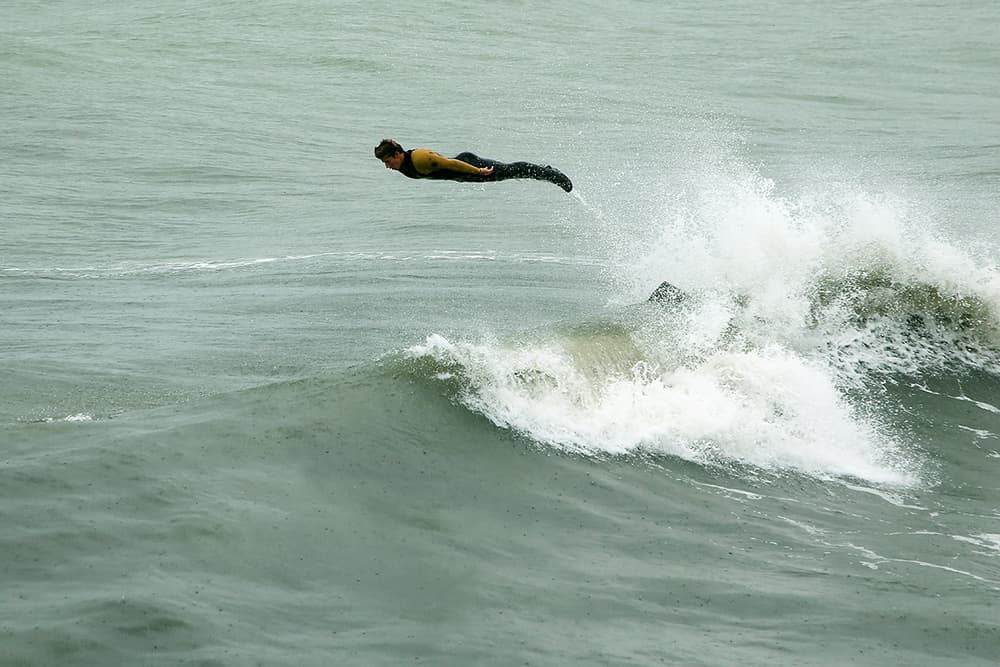 Surfer Flying Over Wave by Massimo Della Latta — canvas wall art
