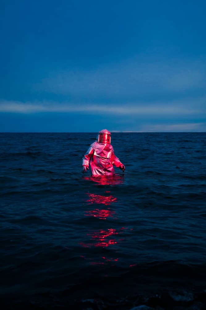 Red Suit Blue Sea by Samantha Hearn — canvas wall art