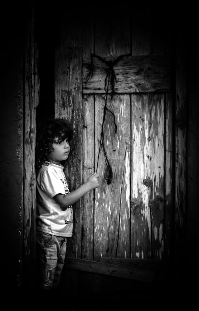 Pensive Child Old Door by RABIA BASHA ARTIST — canvas wall art