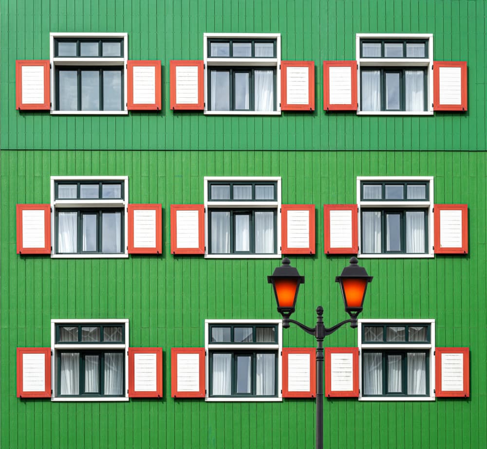 Red Shutters Green Facade by Roland M Schwerdtfeger — canvas wall art