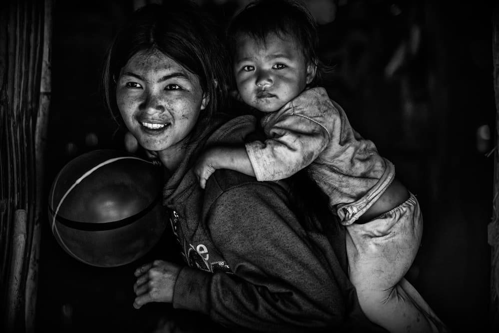 Smiling Sister And Baby by Joxe Inazio Kuesta Garmendia — canvas wall art