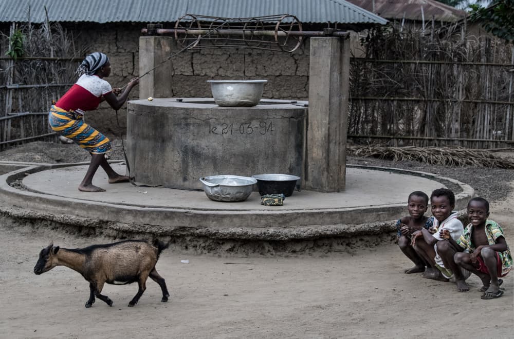 Drawing water from the well in a little village in Benin by Joxe Inazio Kuesta Garmendia — canvas wall art