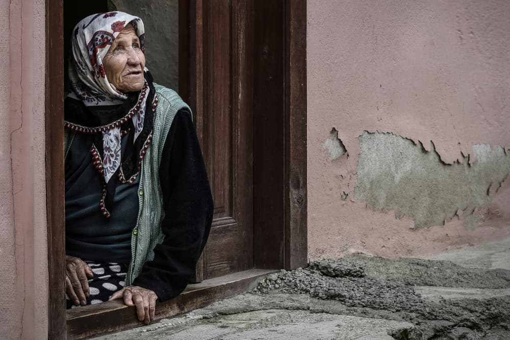 Elderly Woman Looking Out by Irene Perovich — canvas wall art