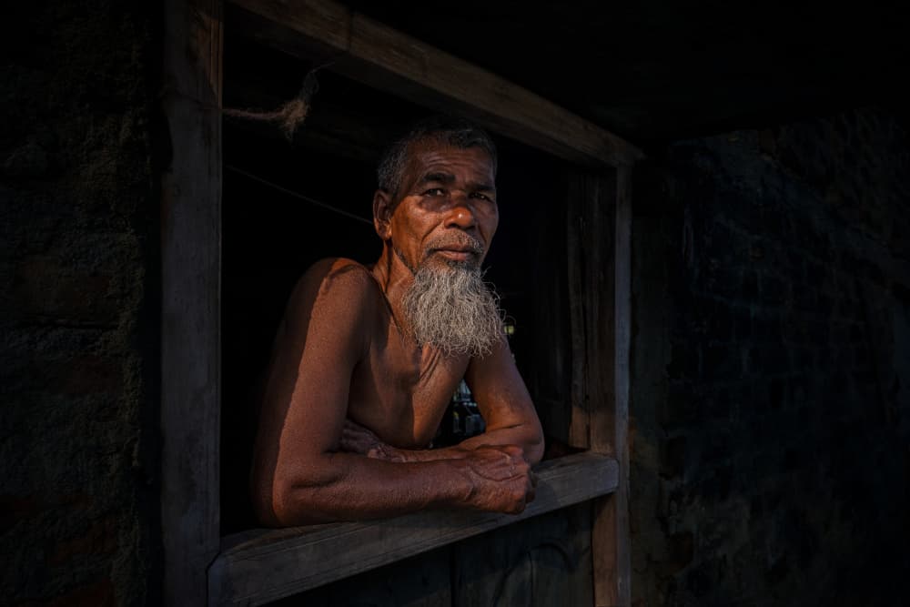 Elder Man In Window Light by Kuntal Biswas — canvas wall art
