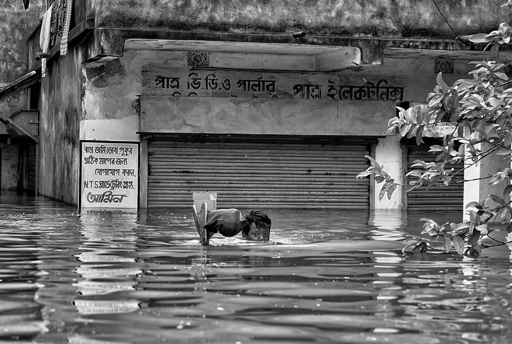Child In Floodwaters by Avishek Das — canvas wall art