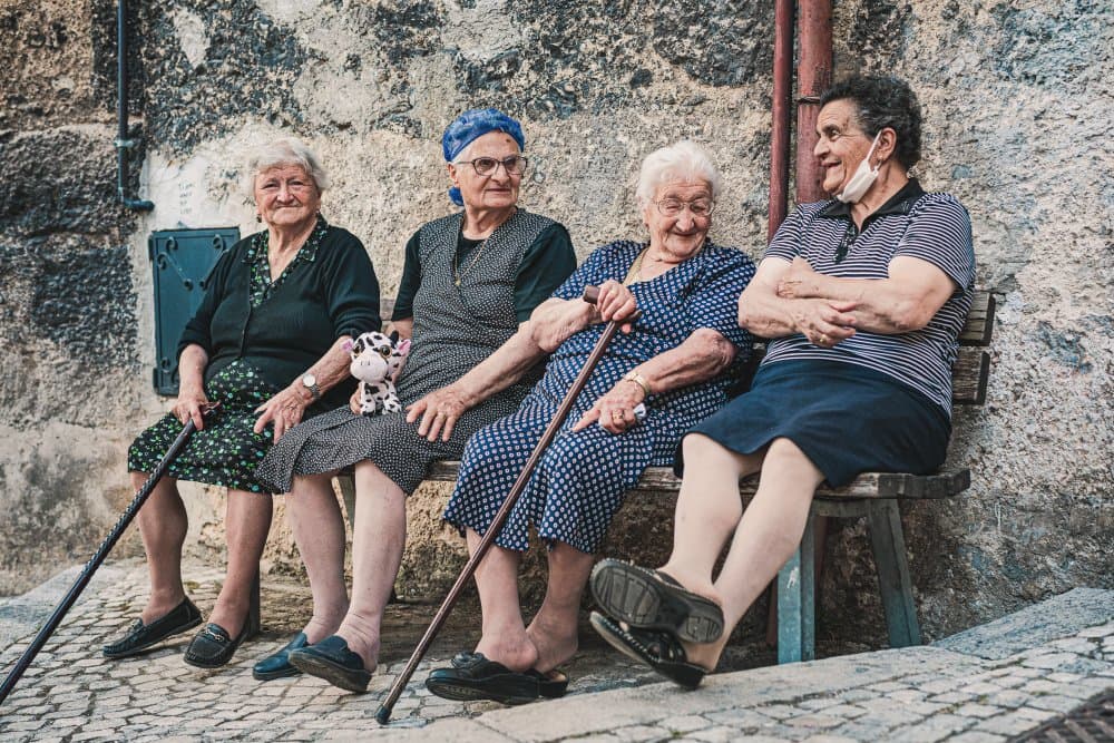 Elderly Friends Chatting by Marco Tagliarino — canvas wall art