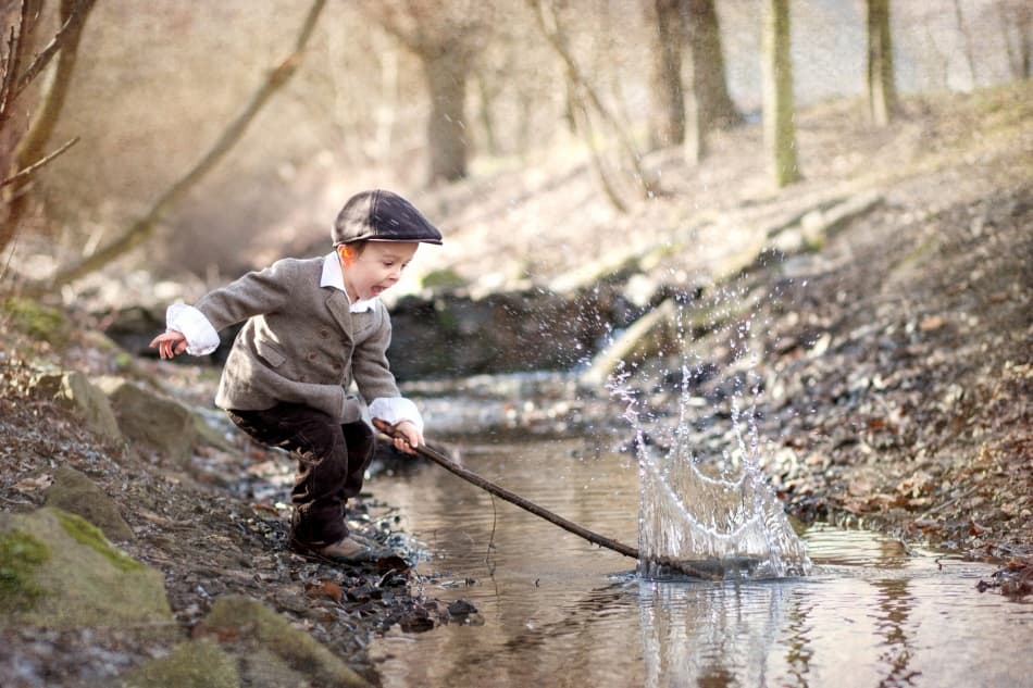Boy Splashing In Stream by Tatyana Tomsickova — canvas wall art