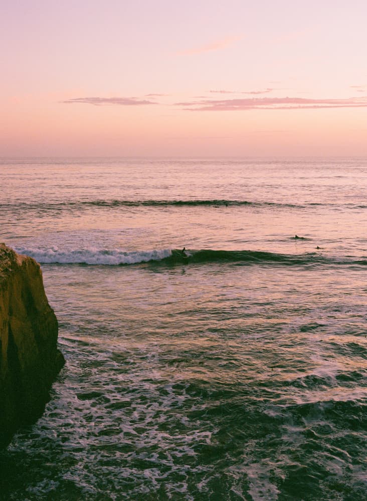 Pink Sunset Surfers by Bethany Young — canvas wall art