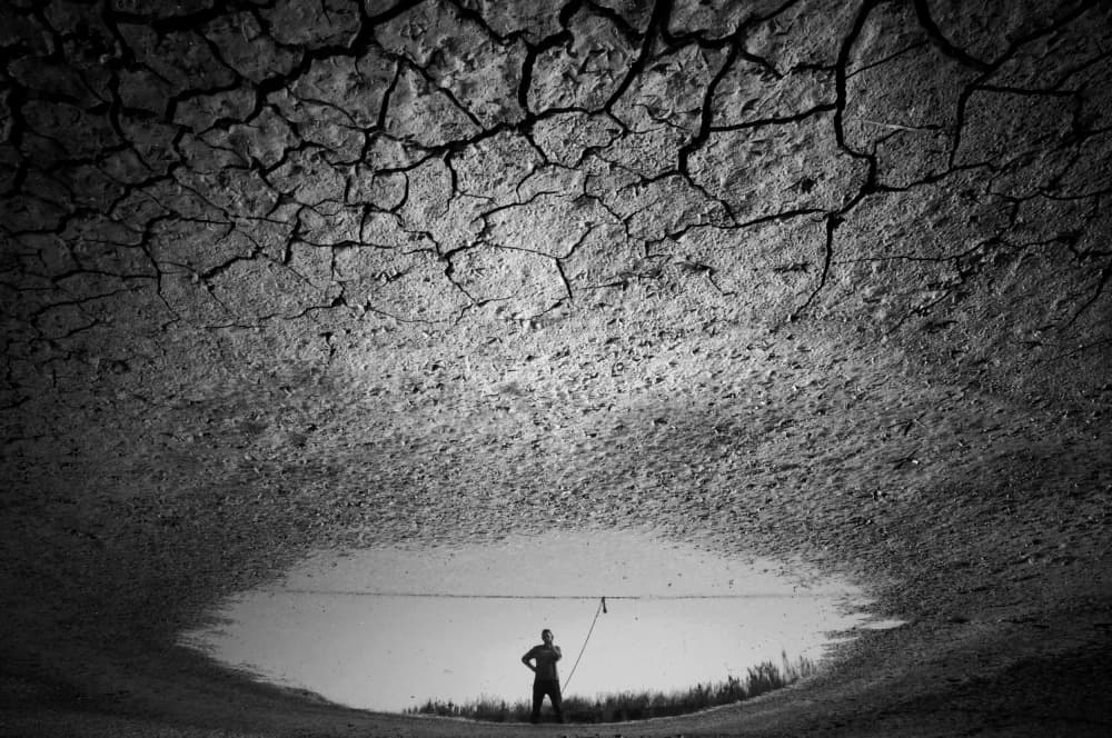 Cracked Earth Man Reflection by Miki Meir Levi — canvas wall art