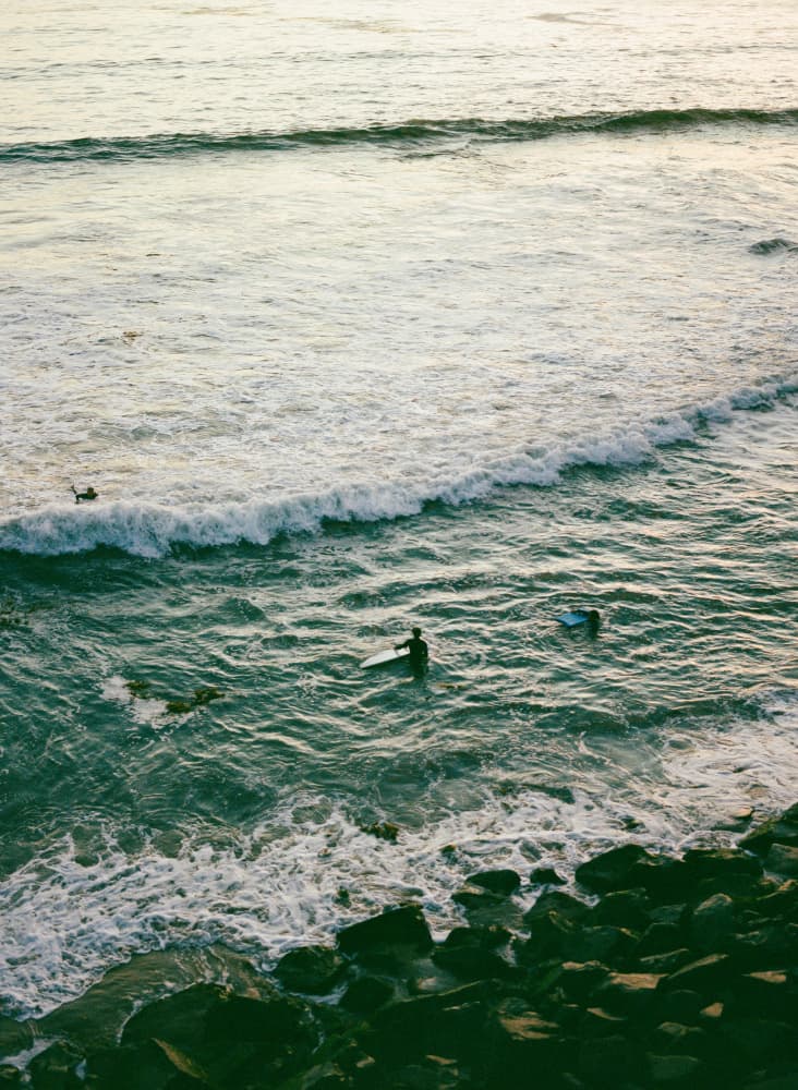 Surfers In Ocean Waves by Bethany Young — canvas wall art