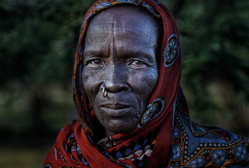 African Woman Red Scarf by Joxe Inazio Kuesta Garmendia — canvas wall art