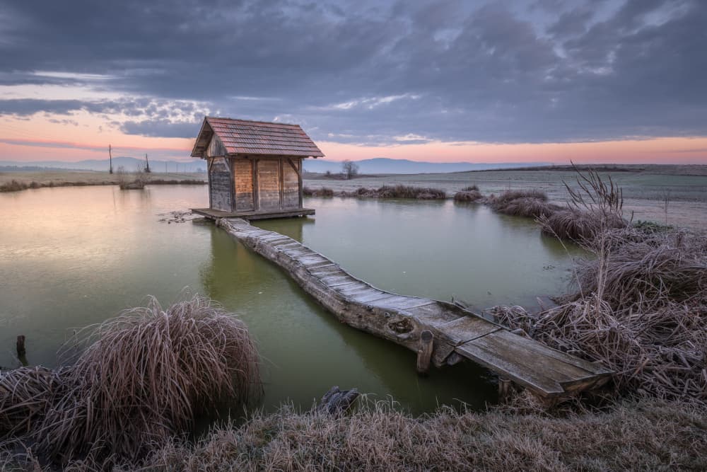 Rustic Cabin Winter Dawn by Joško Šimic — canvas wall art