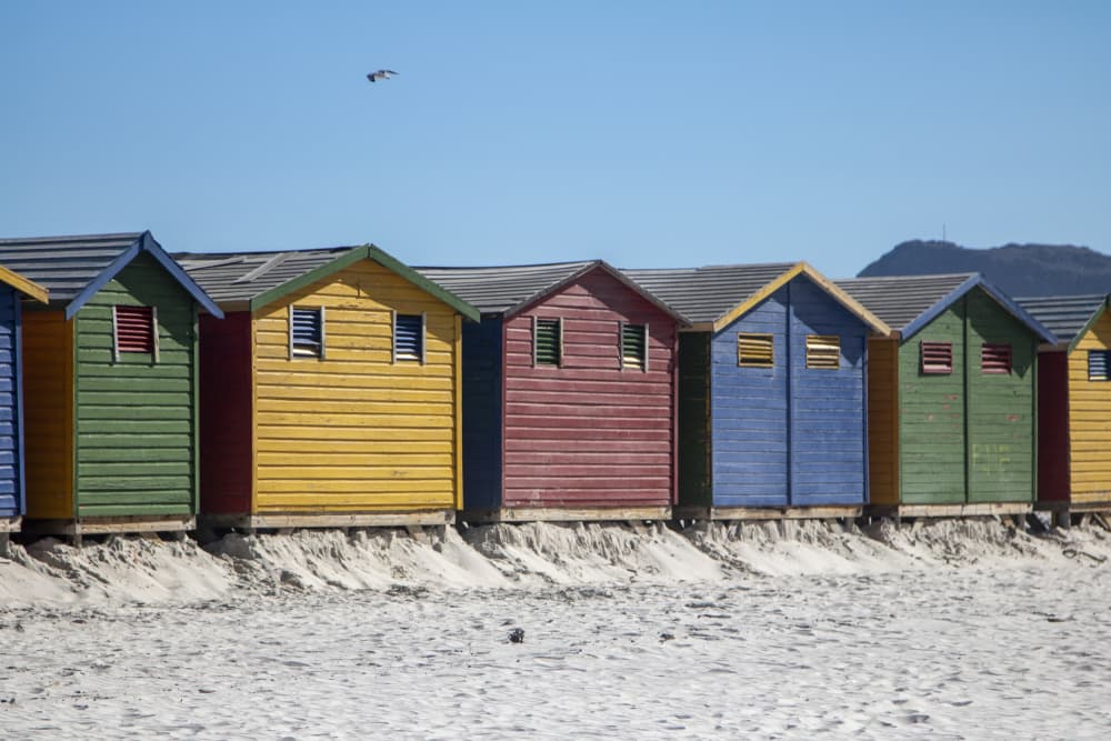 Colorful Beach Huts by Megan Shone — canvas wall art