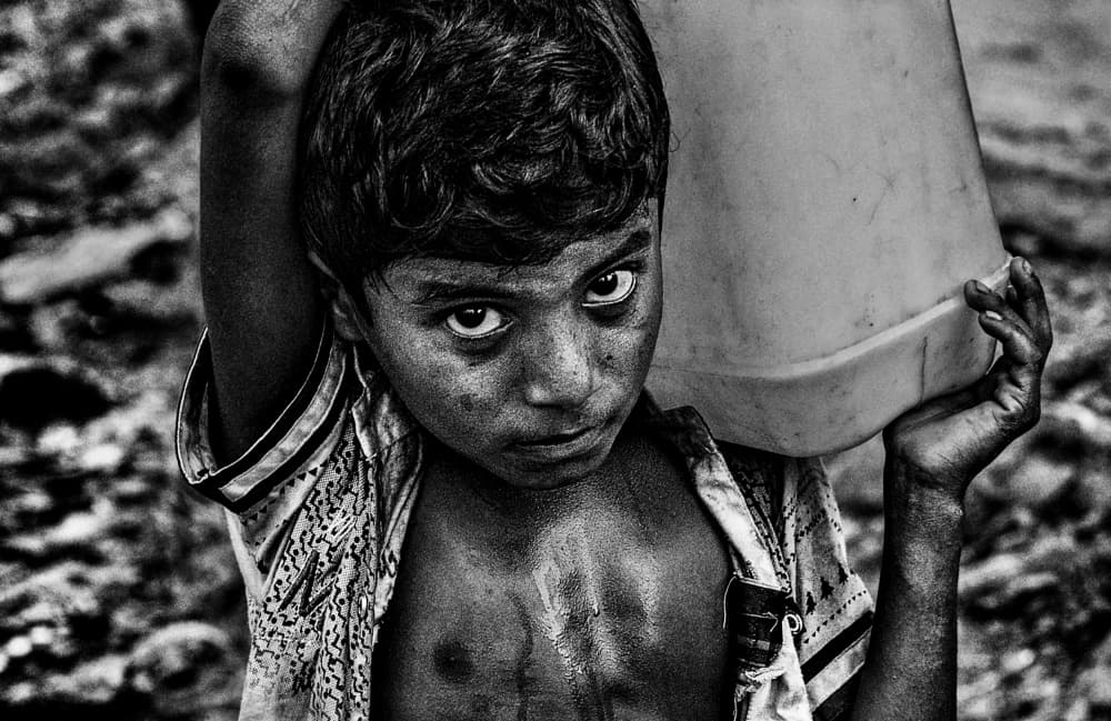 Solemn Boy Carrying Water by Joxe Inazio Kuesta Garmendia — canvas wall art