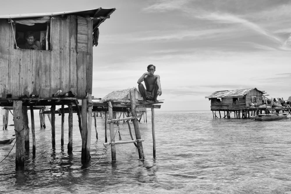 Man in Stilt Village by Kieron Long — canvas wall art