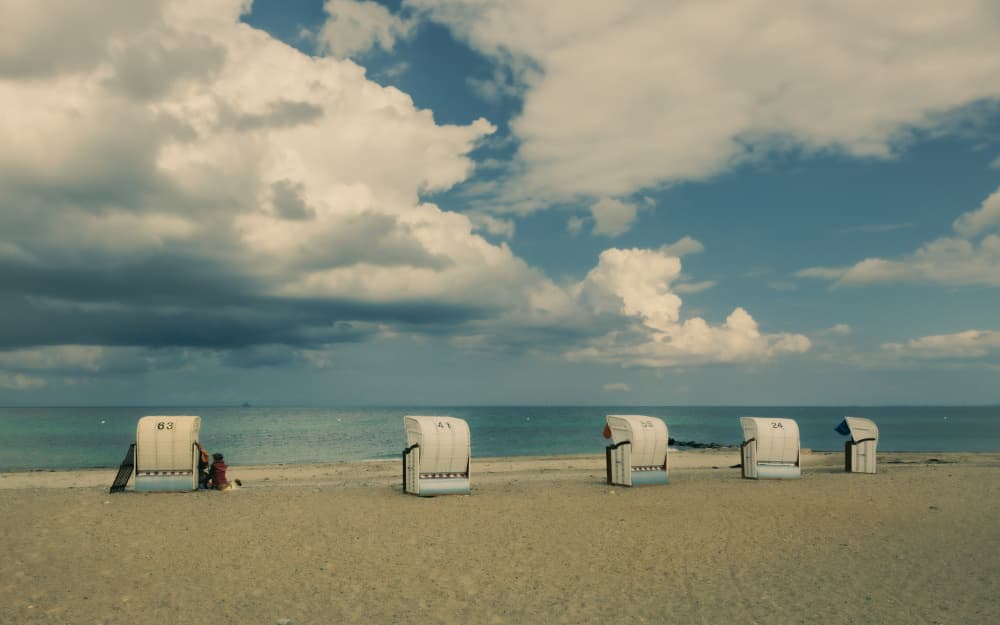 Beach Chairs Under Cloudy Sky by Stephanie Kleimann — canvas wall art