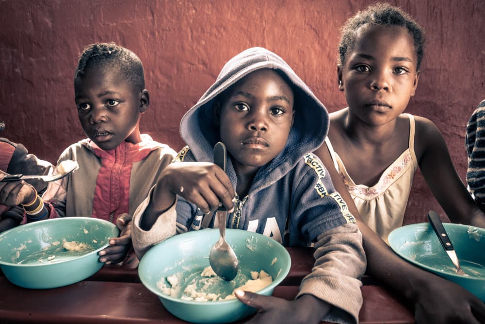 Himba kids at Lunch by Eyal Alcalay — canvas wall art