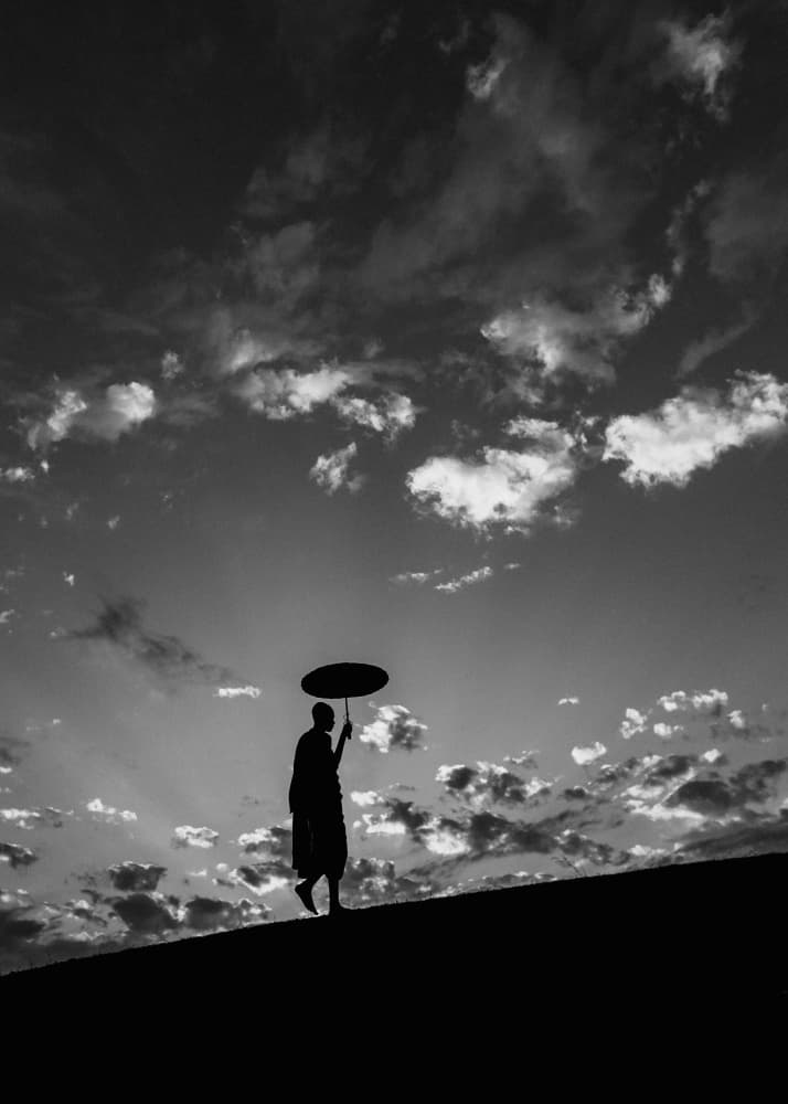 Monk Under Cloudy Sky by ADIREK M — canvas wall art