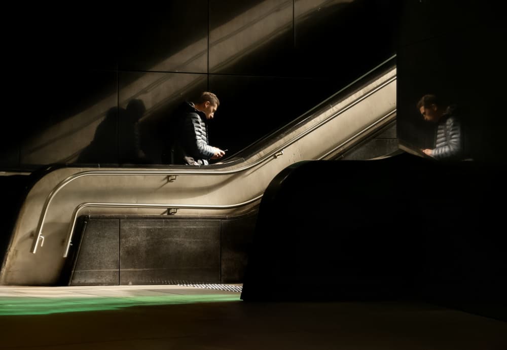 Escalator Man Reflection by Anna Niemiec — canvas wall art