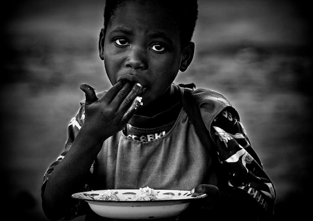 Young Boy's Meal by Joxe Inazio Kuesta Garmendia — canvas wall art