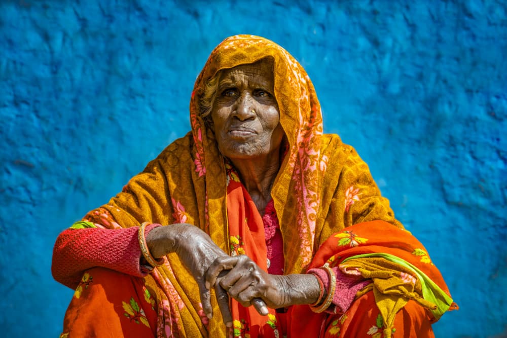 Orange Sari Blue Wall by Linda Wride — canvas wall art