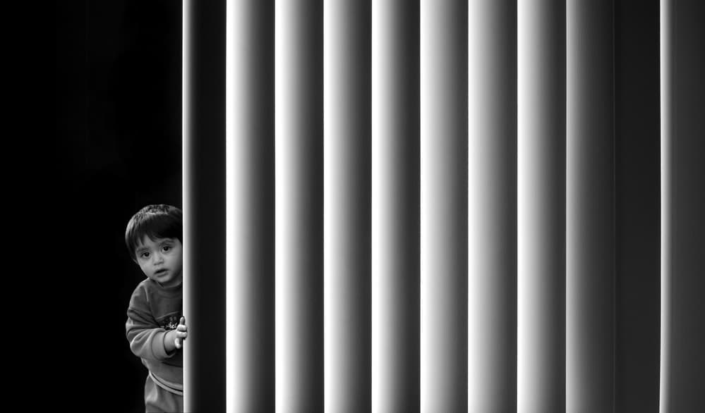 Curious Child Peeking by Huib Limberg — canvas wall art