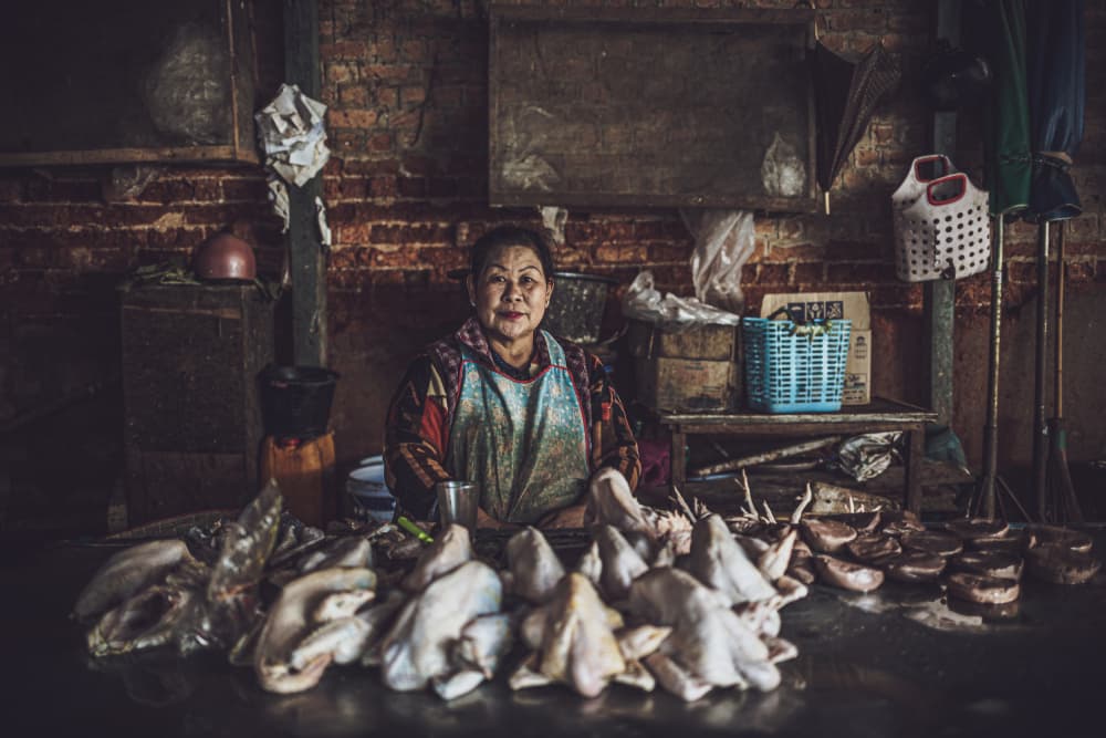 Smiling Market Vendor by Marco Tagliarino — canvas wall art