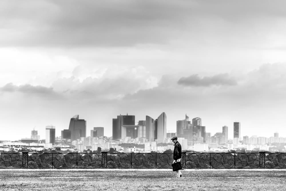 Man Walks City Skyline by Boris Hristov — canvas wall art