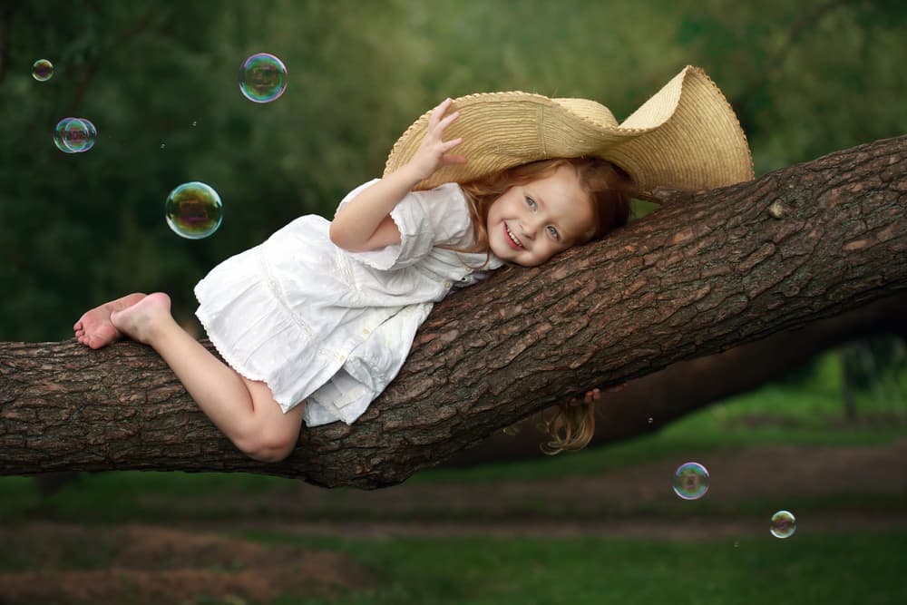 Happy Girl In Tree by Victoria Glinka — canvas wall art