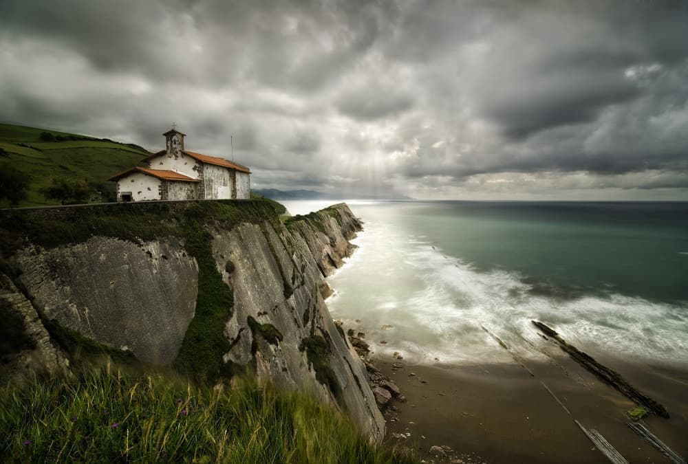 Dramatic Cliffside Church by Fran Osuna — canvas wall art