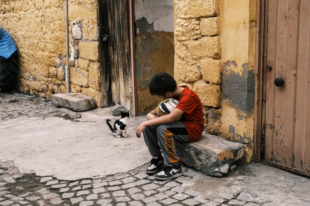 Contemplative Boy and Cat by Ali Ayer — canvas wall art