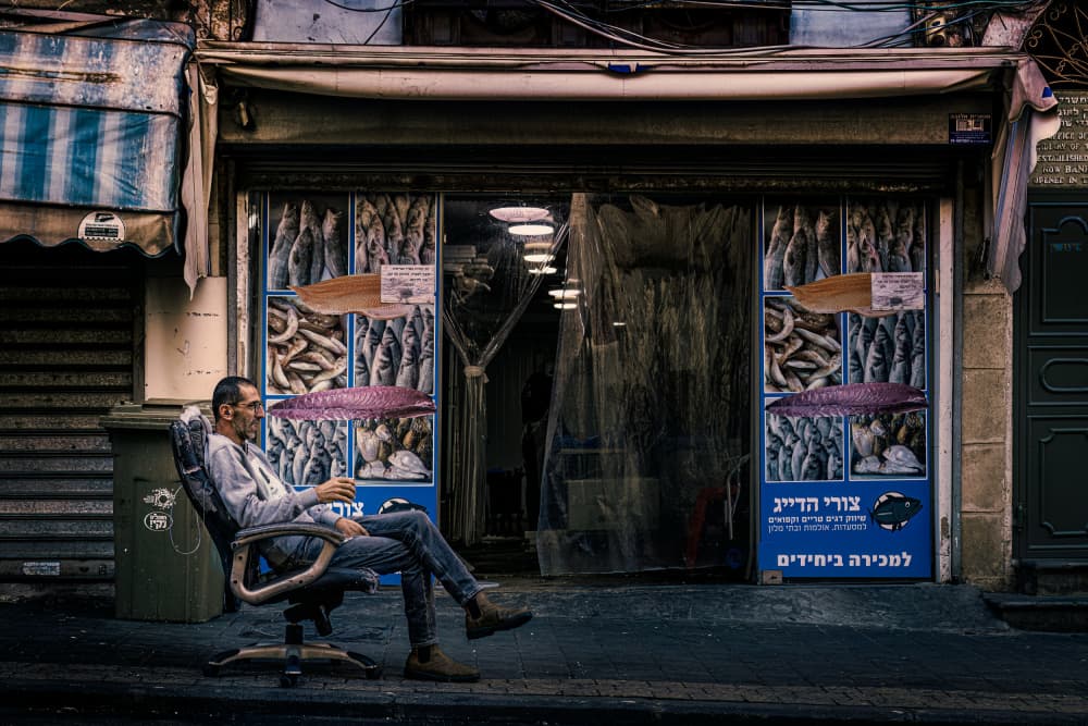 Man Outside Fish Shop by Marco Tagliarino — canvas wall art