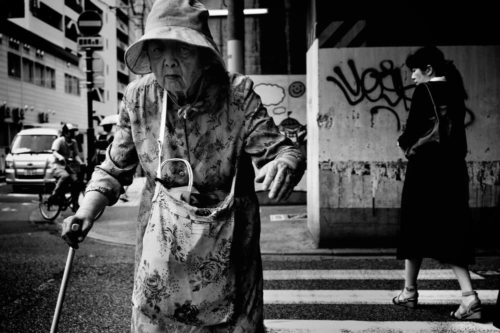 Elderly Woman City Walk by Shinji Isobe — canvas wall art