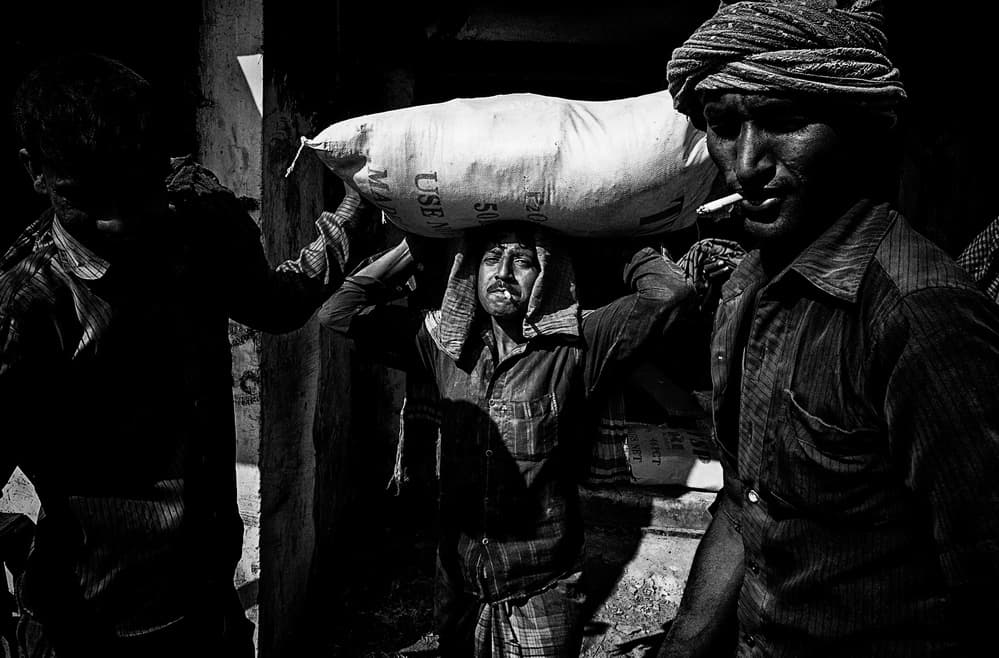 Street Laborers Carrying Sack by Joxe Inazio Kuesta Garmendia — canvas wall art