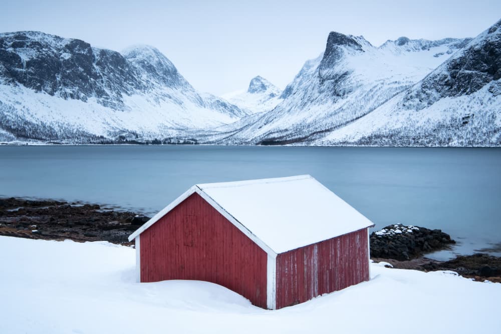 Red Cabin Snowy Fjord by Susanne Landolt — canvas wall art