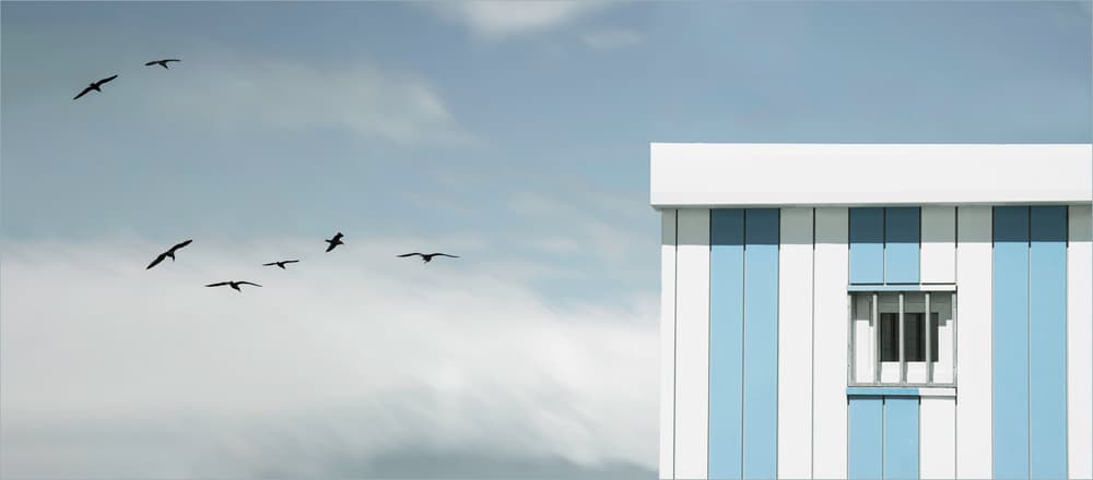 Flight Over Blue Building by Gilbert Claes — canvas wall art