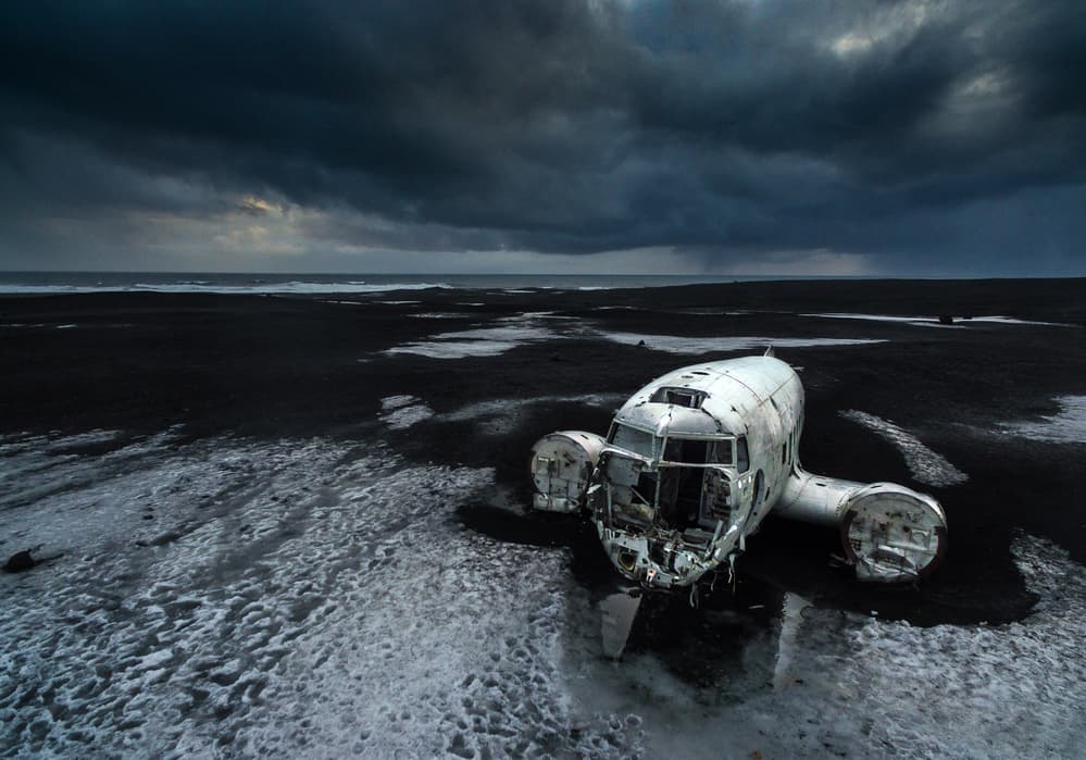 Abandoned Plane Black Beach by Marc Pelissier — canvas wall art