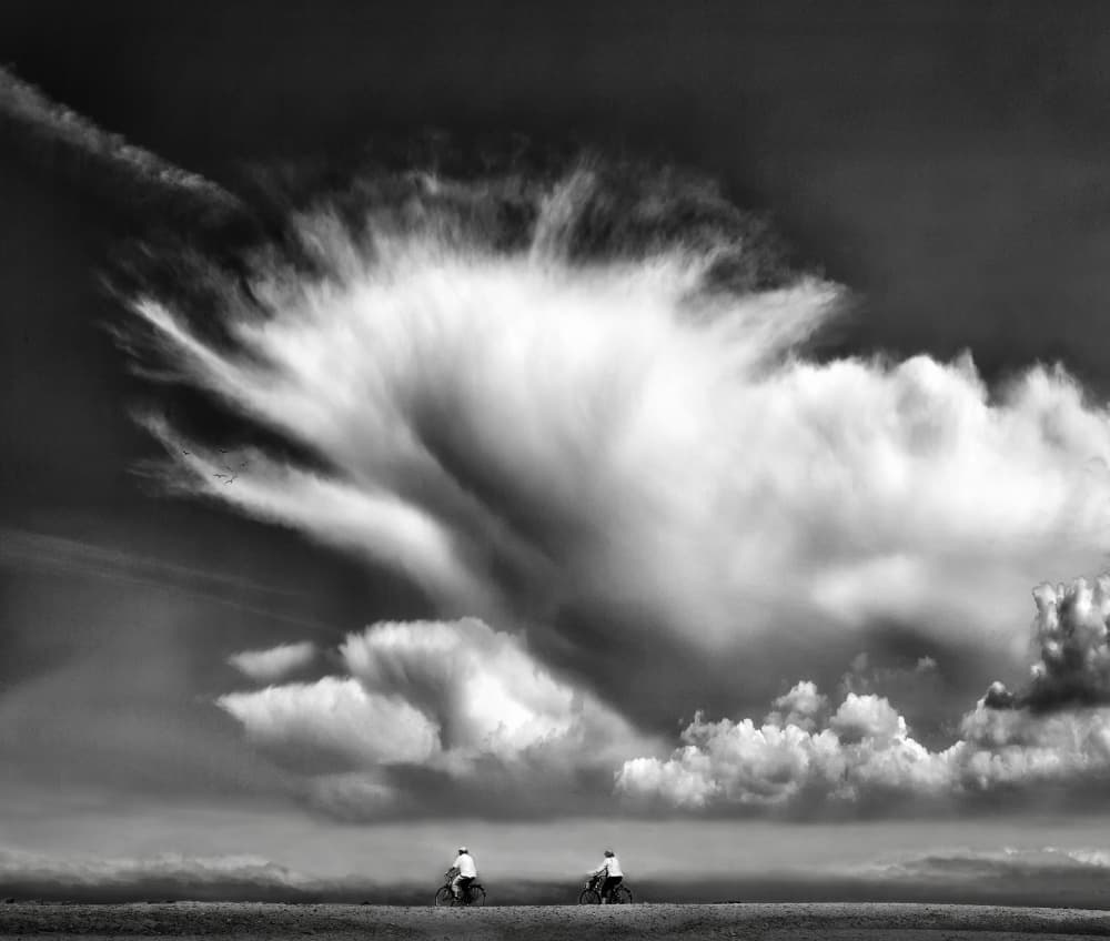 Cyclists Under Dramatic Sky by Yvette Depaepe — canvas wall art