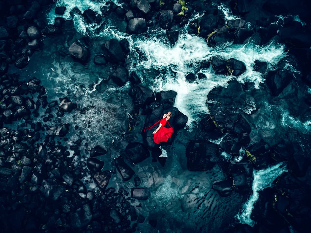 Red Dress on River Rocks by Ruslan Bolgov — canvas wall art