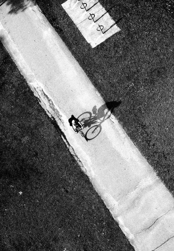 Bicycle Shadow Ride by Jian Wang — canvas wall art