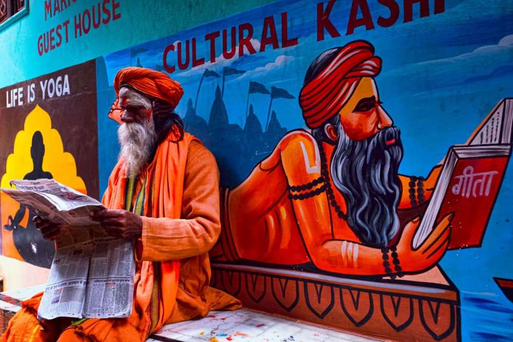 Indian Sadhu Reading Newspaper by Ajit Kumar Majhi — canvas wall art