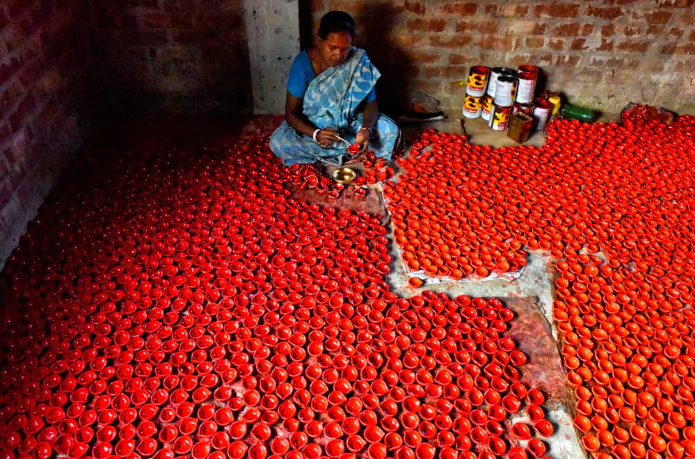 Indian Woman Painting Diyas by Avishek Das — canvas wall art