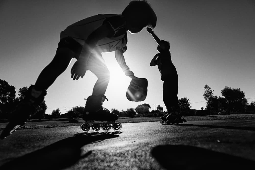 Sunlit Skating Kids by Despird Zhang — canvas wall art