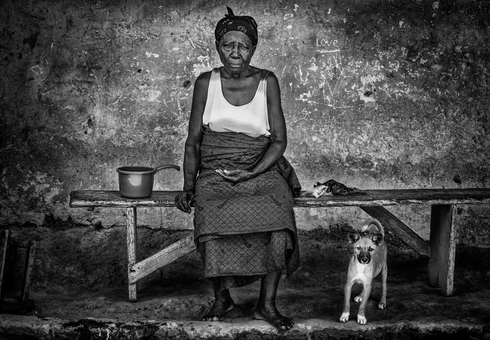 Elderly Woman And Dog by Joxe Inazio Kuesta Garmendia — canvas wall art